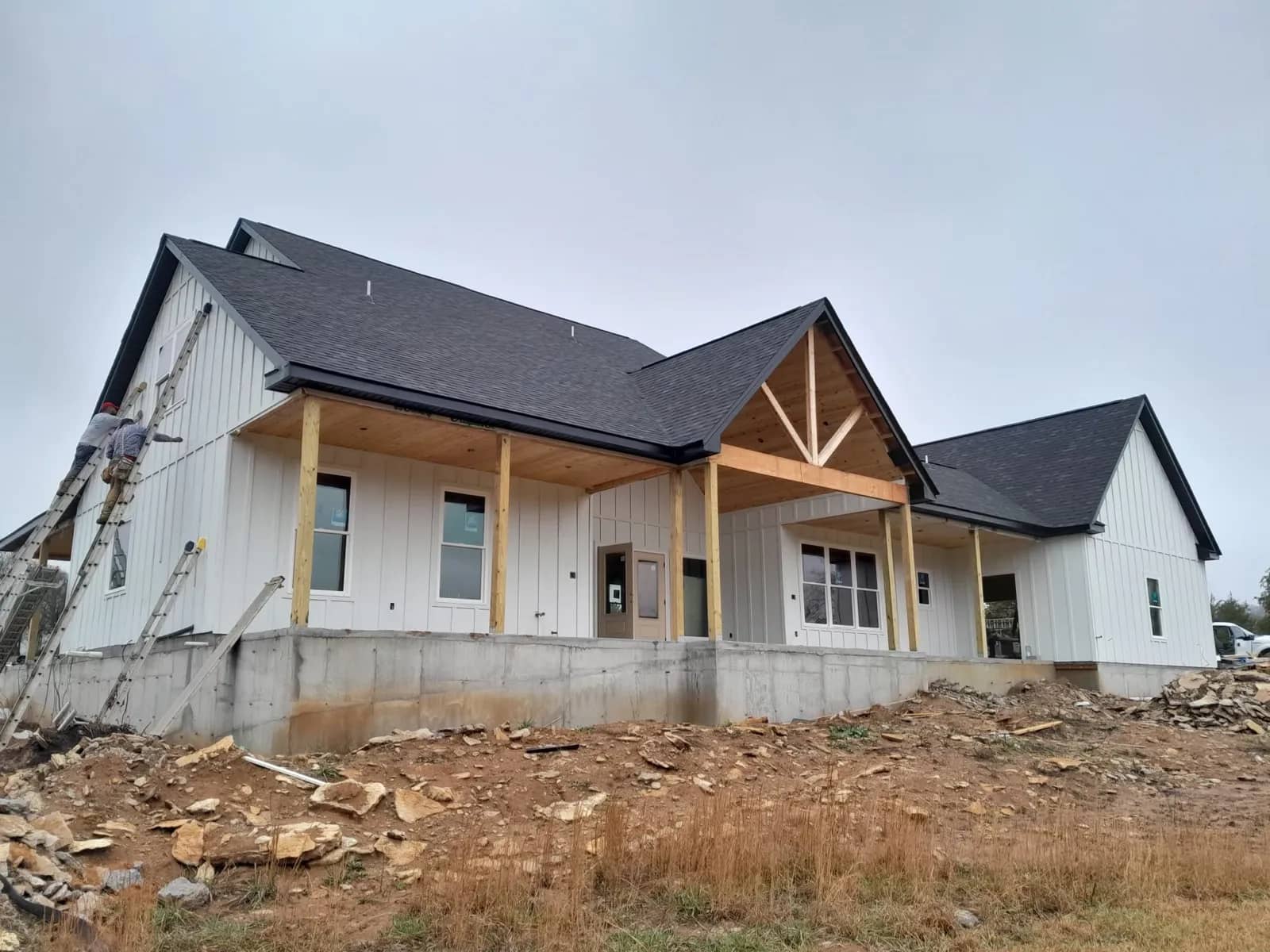 Newly built modern farmhouse custom home with board-and-batten siding and a covered front porch in Middle Tennessee