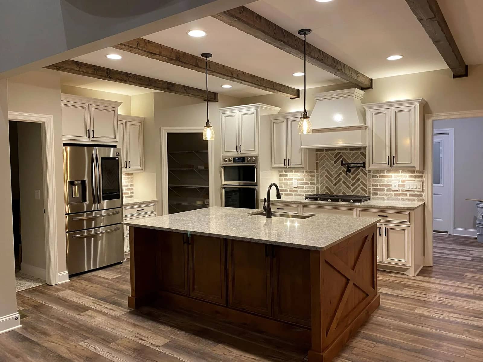 Remodeled kitchen with a custom island and brick backsplash