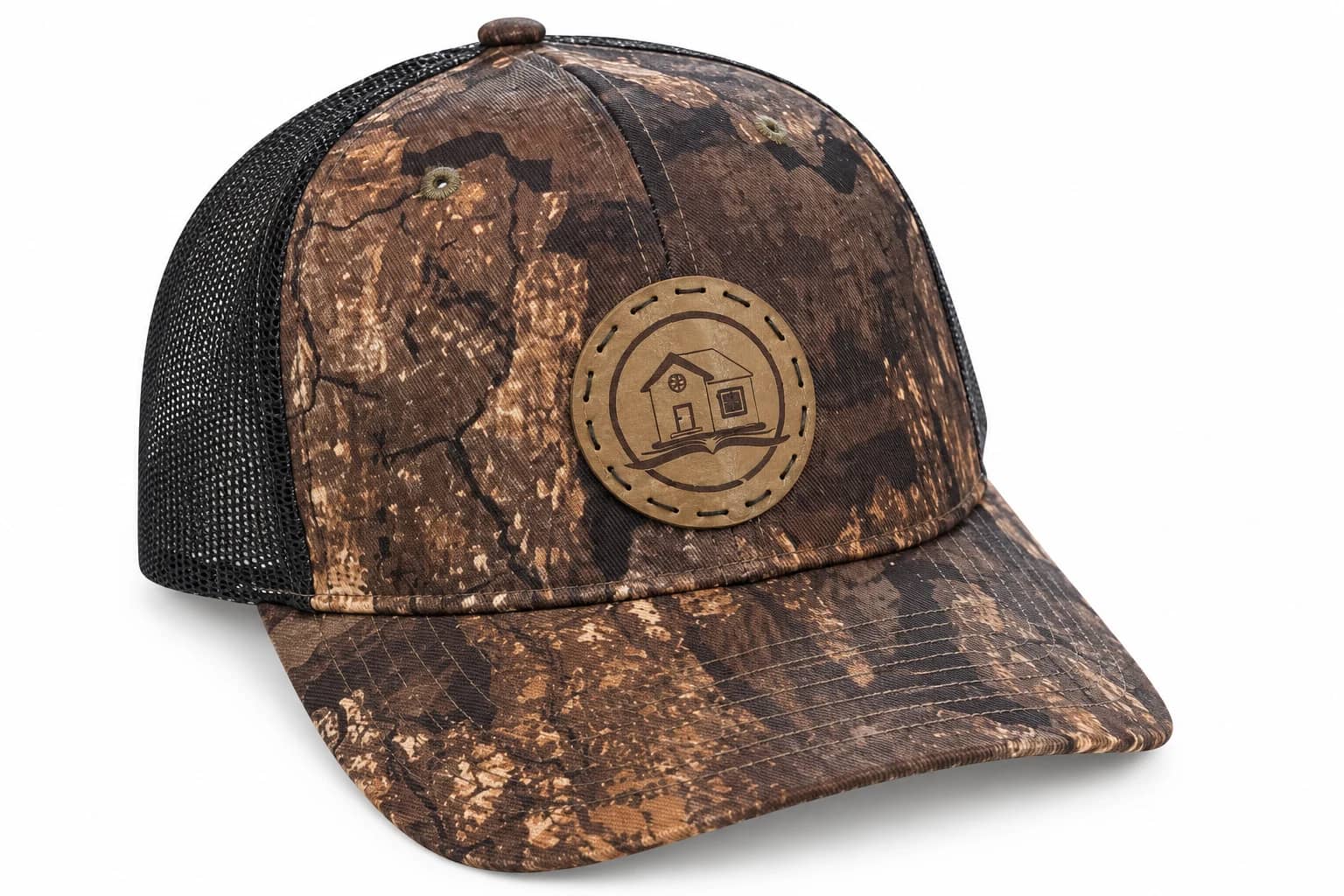 Brown woodland camouflage trucker hat with a tan circular house-and-book patch.